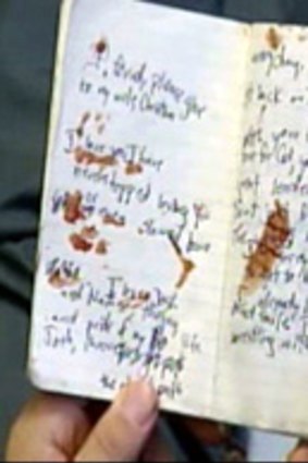 The blood-stained notebook Woolley used to scrawl messages to his family.