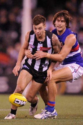 Caught: Ryan Griffen tackles Jamie Elliott.