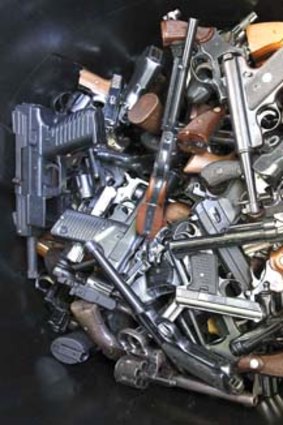 Hand guns accumulate in bin at a gun buyback held by the Los Angeles Police Department.