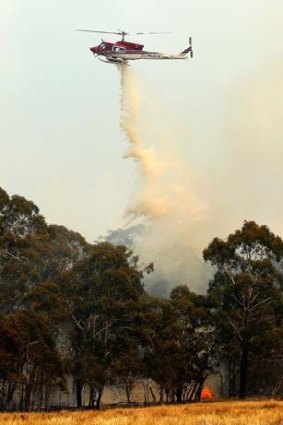 Relief &#8230; a helicopter attacks a fire at Sandhills.