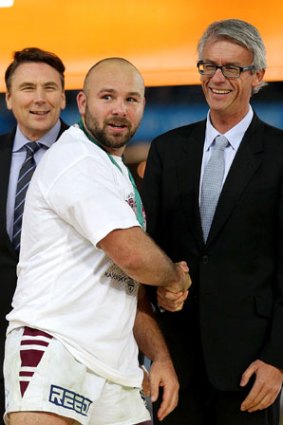Hard to handle ... Clive Churchill medalist Glenn Stewart shakes hands with NRL CEO David Gallop.