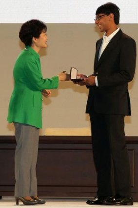 South Korean President Park Geun-Hye gives a medal to Manjul Bhargava.