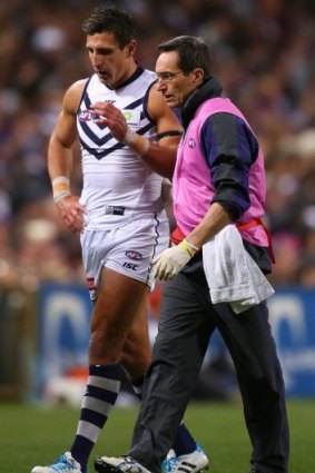 Matthew Pavlich is assisted from the field against Carlton.