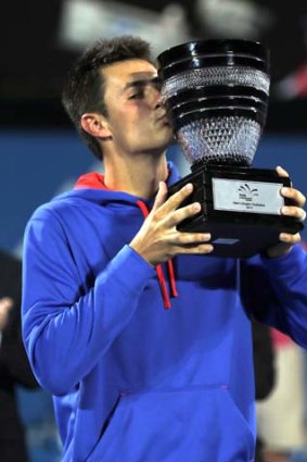 Bernard Tomic kisses his winner's trophy after defeating South Africa's Kevin Anderson in the final.