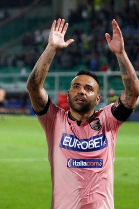 Victory-bound: Fabrizio Miccoli salutes Palermo fans.