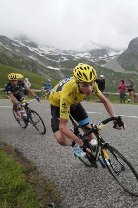 Yellow machine: Chris Froome charges on during Friday's 19th stage in pursuit of victory in the Tour de France.