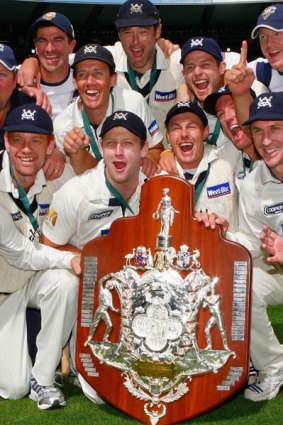 The Bushrangers pose with the Sheffield Shield after beating Queensland in March.