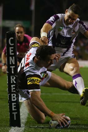 Finishing touch: Penrith's David Simmons scores under pressure from the Storm's Billy Slater.