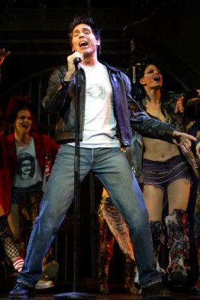 Michael Falzon on stage in <em>We Will Rock You</em>.