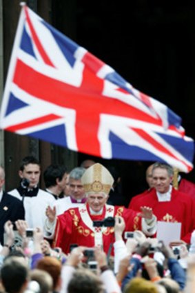 Pope Benedict waves to pilgrims outside Westminster Cathedral after holding Mass.