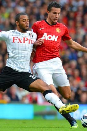 At full stretch &#8230; Fulham's Moussa Dembele challenges Robin van Persie for the ball at Old Trafford.