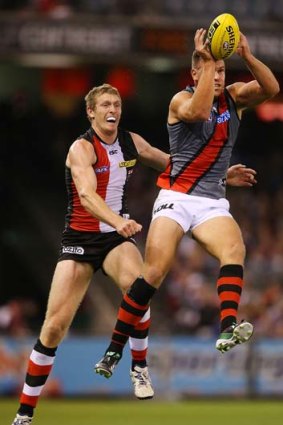 Big task: St Kilda ruckman Ben McEvoy trails Essendon opponent David Hille during the Bombers' victory on Saturday night. The Saints' injuries forced McEvoy to ruck alone.