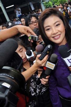Yingluck Shinawatra faces the media after voting in the Thailand election. Pre-election polls had  her Puea Thai party out in front.