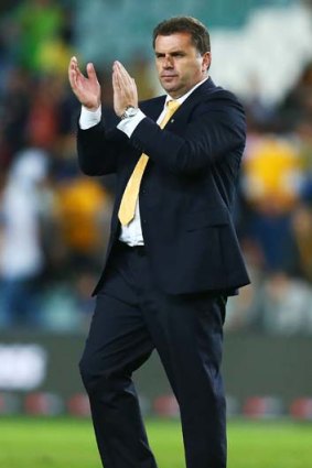 Socceroos coach Ange Postecoglou acknowledges fans at full time.