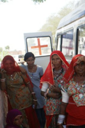 Women and children at a mobile health van in Barmer.