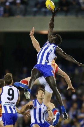 North's Majak Daw goes up for the ball along with Daniel Merrett of the Lions. 