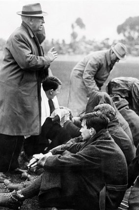 Reality Checker: Norm Smith’s successor at Melbourne, Frank ‘‘Checker’’ Hughes, speaks to players in 1965.