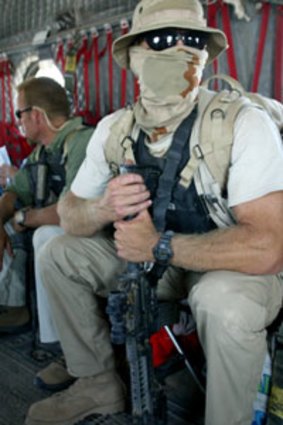 A private contractor waits in a helicopter at the height of the Iraq war.