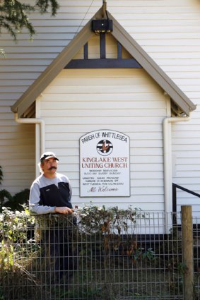 Eddie Sabljak stands outside the Kinglake West church that he helped to save from fire.