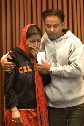 Harjit Singh Channa comforts his wife Harpreet Kaur who broke down in tears after she spoke to family and friends during the memorial service for her son Gurshan Singh Channa.