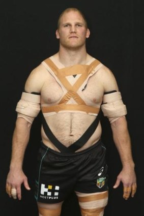 True warrior: Nigel Plum shows how he is strapped up to reduce pain and injury during games.
