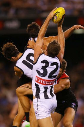 Travis Cloke of the Magpies marks the ball against the Bombers.