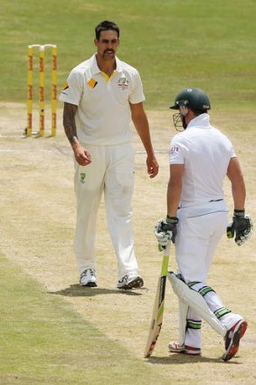 Australian bowler Mitchell Johnson looks at AB De Villiers after getting him out during day three of the Test.