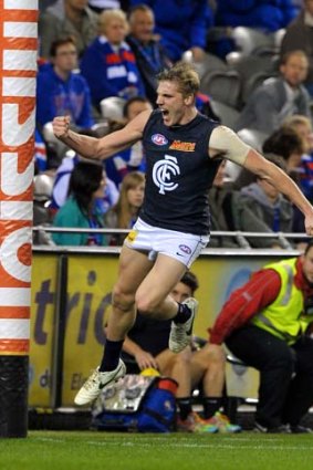 Party time: Tom Bell celebrates his maiden AFL goal.