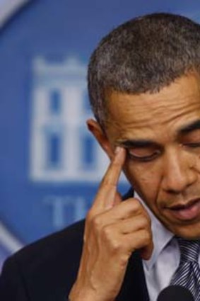 The US President, Barack Obama, wipes a tear as he speaks about the shooting during a press briefing at the White House.