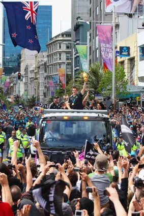 Blackout &#8230; Richie McCaw holds the cup aloft as fans line the streets of Auckland.