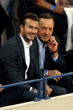 Kevin Spacey and David Beckham watch the men's singles final match.