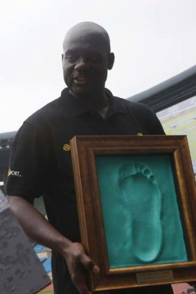 Johnson holds a cast of his footprint made after running on the track at the Seoul Olympic Stadium on Tuesday.