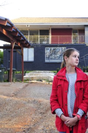 The Ross family: Nathalie with her children, Charlie, 8, Grace,13, and Lulu, 5, outside their family home which is contaminated with Mr Fluffy asbestos. 