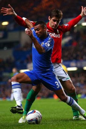 Ashley Cole of Chelsea is closed down by Danny Graham of Swansea City.