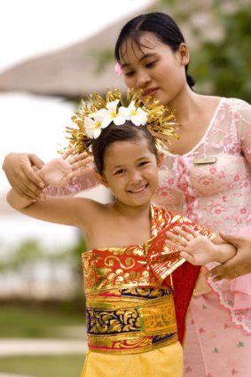 A girl dresses up in Balinese clothes at the Kura Kura club.