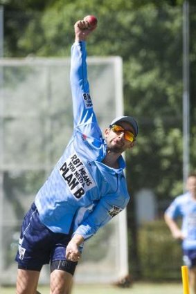 Nathan Lyon bowls in the Manuka Oval nets during NSW training on Monday.