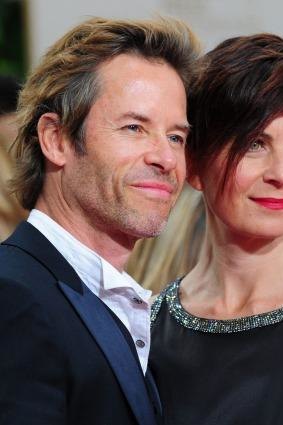 Actor Guy Pearce (R) and wife Kate Mestitz arrive on the red carpet for the 69th annual Golden Globe Awards at the Beverly Hilton Hotel in Beverly Hills, California, January 15, 2012.