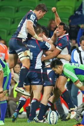 Jubilation: Nick Phipps and the Rebels celebrate after Bryce Hegarty scored the match-winning try.