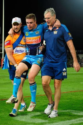 Luke O'Dwyer of the Titans is carried off.