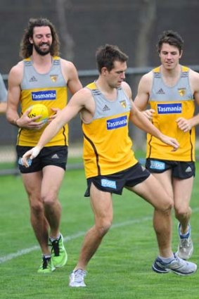 Hawthorn skipper Luke Hodge shows off his soccer skills to teammates Matt Spanger and Isaac Smith at a recovery session on Monday. Hodge proved to be crucial in swinging the qualifying final against Sydney Hawthorn's way.