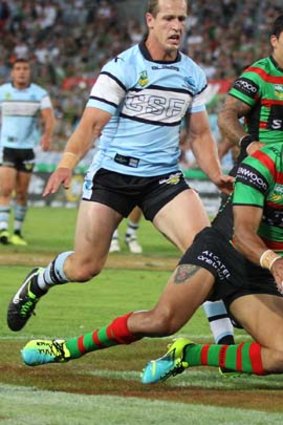 Try time: South Sydney's Dylan Farrell goes over against Cronulla on Monday night.