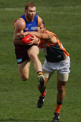 Daniel Merrett of the Lions marks over Tim Mohr of the Giants during their match at the Gabba.