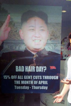 Bad hair day: Barber Karim Nabbach at the hair dresser in the west London with the ad that sparked an international brouhaha.