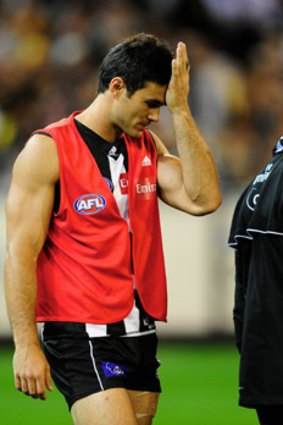 Collingwood's Chris Tarrant goes off with injury in the first quarter.