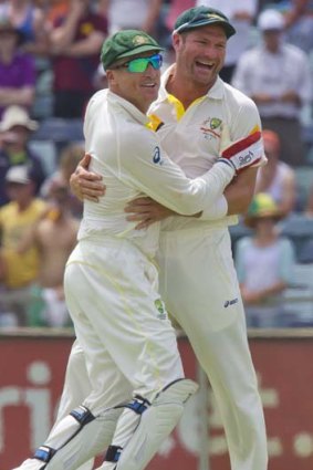 Australian bowler Ryan Harris (left) and wicketkeeper Brad Haddin (right) celebrate.