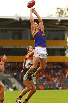 Higher, higher: Scott Selwood's marking attempt falls short during the Eagles' 81-point victory against the Giants.