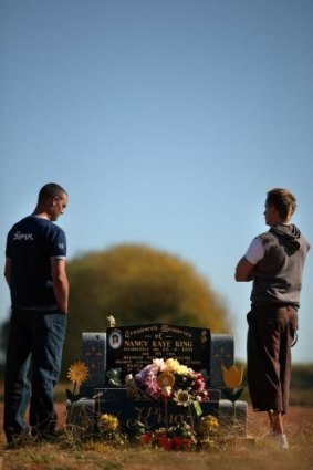 John Kaye, left, and brother Jason at their mother's grave. 