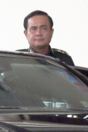 Thai Army Chief General Prayuth Chan-ocha, left, gets in a car as he leaves the Army Club shortly before staging the coup.