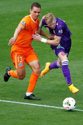 Jade North of the Roar challenges Andy Keogh of Perth Glory during the round two A-League clash in Perth.