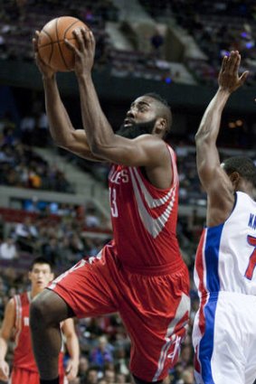 Houston Rockets guard James Harden drives to the basket past Detroit Pistons guard Brandon Knight.